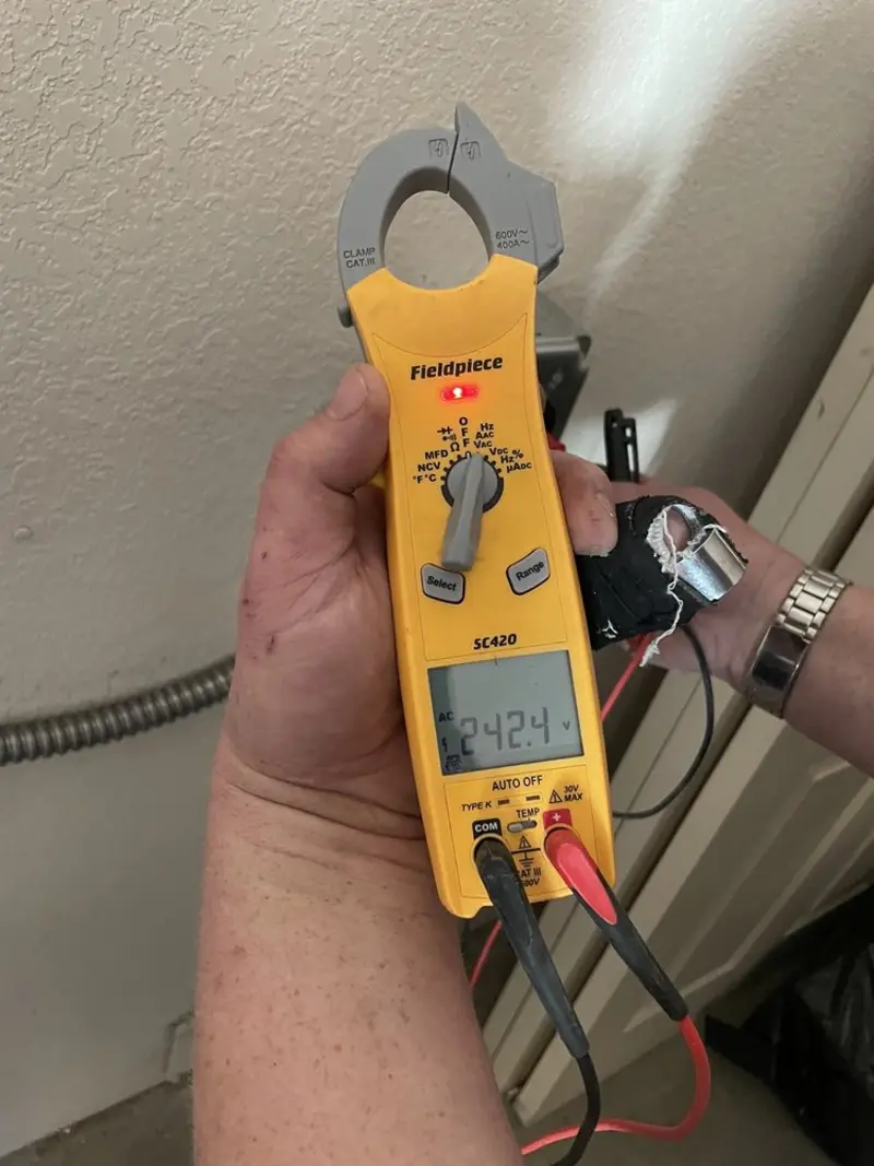 Voltage testing with clamp meter during Outlet Installation in Millstadt